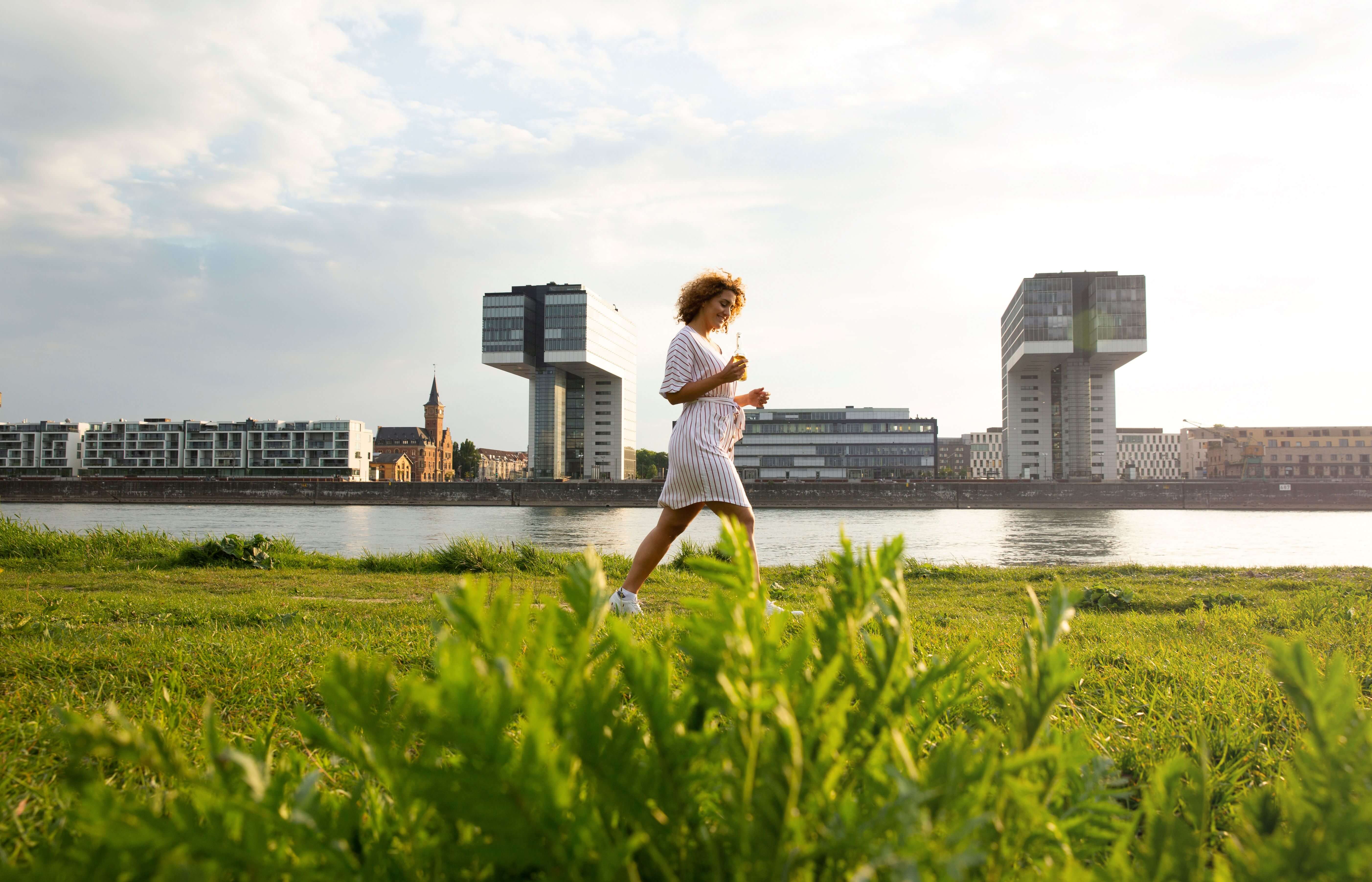  Frau geht am Rhein spazieren 