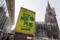 EcoHopping-Plakat vorm Kölner Dom