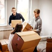 Menschen in einer Wohnung mit Umzugskartons