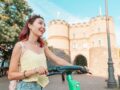 Junge Frau mit E-Scooter in Köln unterwegs